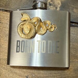 Lana Del Rey Born to Die album, featuring a gold serpent emblem.